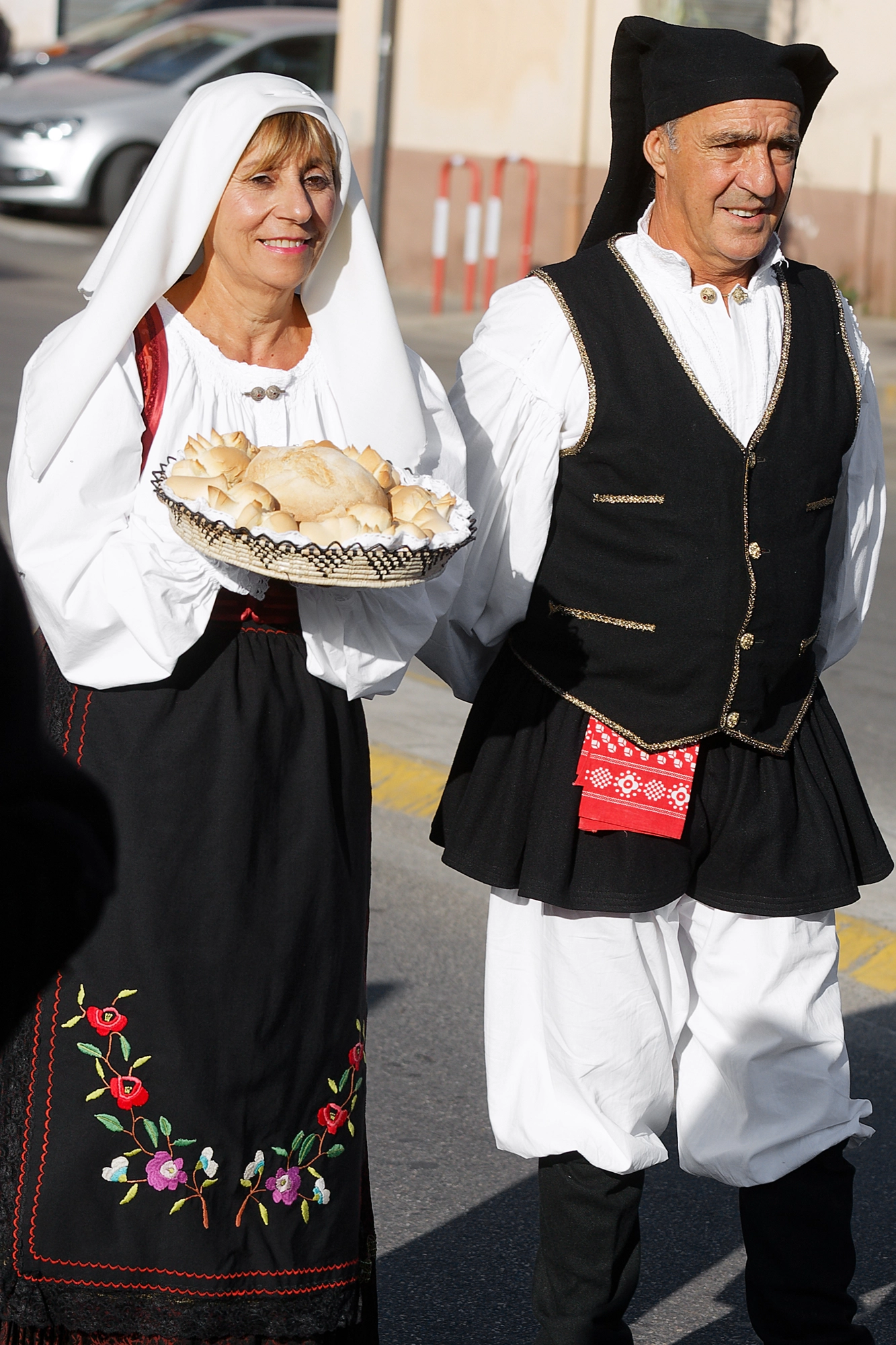 Traditional dress and costume of Barrali - couple in parade with women's festive dress (damask satin gunnedda, brocade cossu, muccadori headscarves) and men's traditional dress of the Trexenta