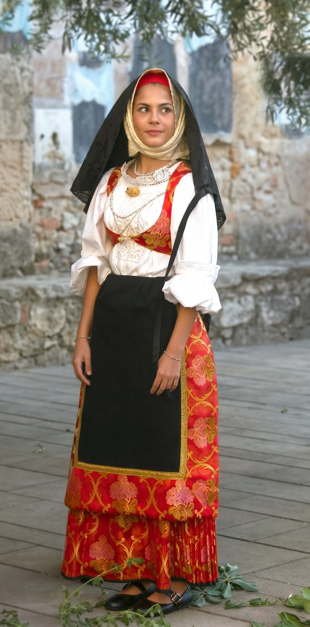 Traditional dress and costume of Bauladu - women's festive dress with red iscaffiottu bonnet, golden muccadore headscarf, broccatello imbustu and black unnedda with wide red brocade frill
